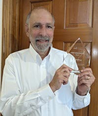 Image of CEO Wayne Greenberg holding the Grid Innovator Award